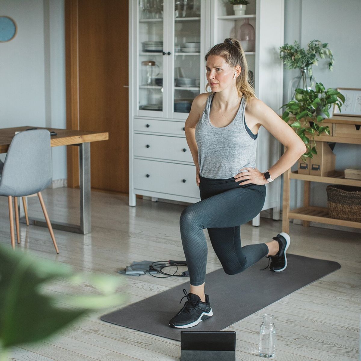 Person in living room following a 20 minute workout sequence